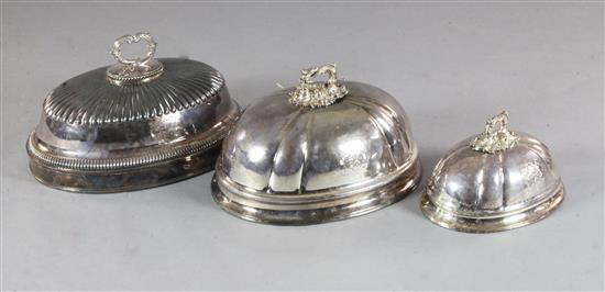 Two Sheffield plate oval domed meat dish covers, engraved with the Heneage family crest, largest 51cm.